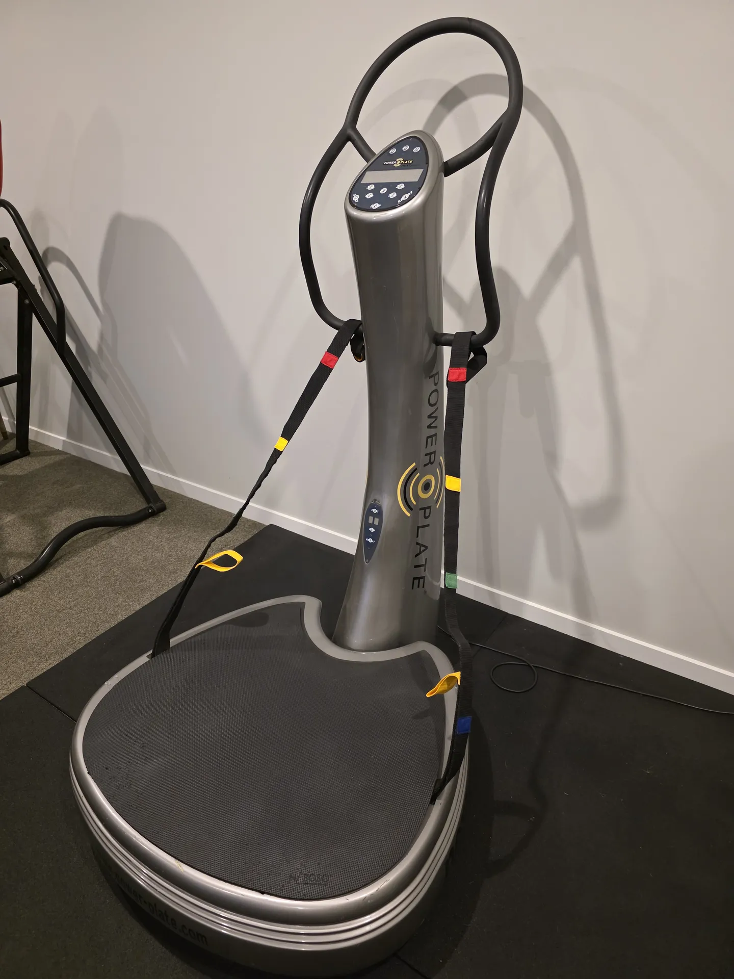 Silver Power Plate Next Generation upright machine with a large plate and training straps
